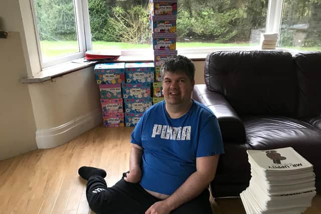 Andy today lives in his own house with assisted care, pictured with his beloved collection of Mr Men books