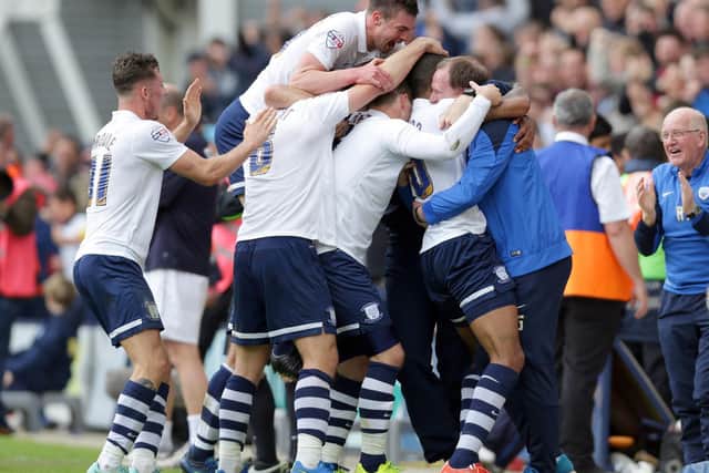 The PNE squad pile-on Jermaine Beckford after his superb goal against Chesterfield in the play-offs