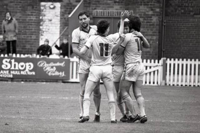 Bob Atkins (left), Gary Brazil and David Johnson congratulate Ian Stevens after the midfielder scored in Preston's win over York on May 11, 1985