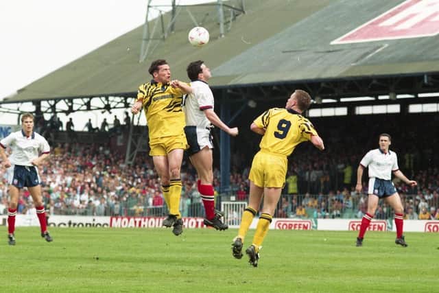 Preston's Neil Whalley and Mickey Norbury jump for a high ball against Bolton at Burnden Park