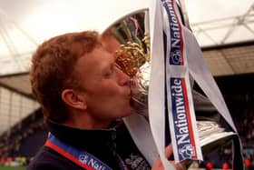 Preston North End manager David Moyes plants a kiss on the Division Two Championship trophy as the team clinched promotion