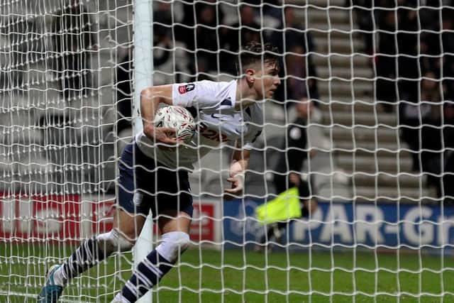 Josh Harrop collects the ball from the back of the net after scoring in PNE's FA Cup defeat to Norwich