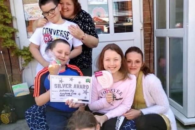 From left to right (back) are Thomas, nana Sue, Joshua, Megan, mum Nicola and Emily Blackwell, who all live together.