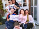 From left to right (back) are Thomas, nana Sue, Joshua, Megan, mum Nicola and Emily Blackwell, who all live together.