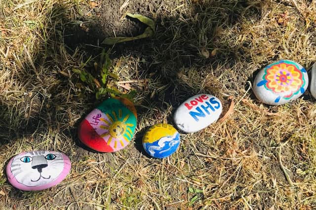 The rocks are painted with colourful designs and laid end to end to resemble a snake