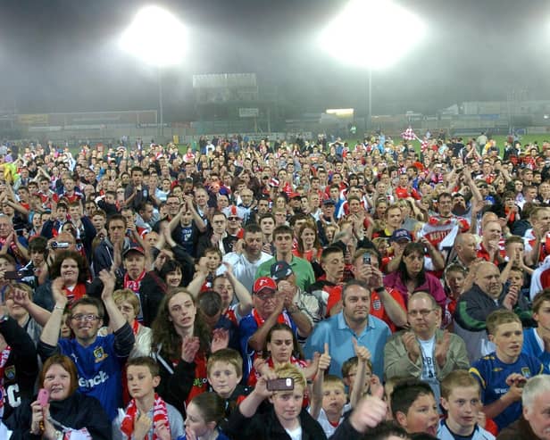 Morecambe fans swamp the pitch at Christie Park at the end of the last ever game at Christie Park.