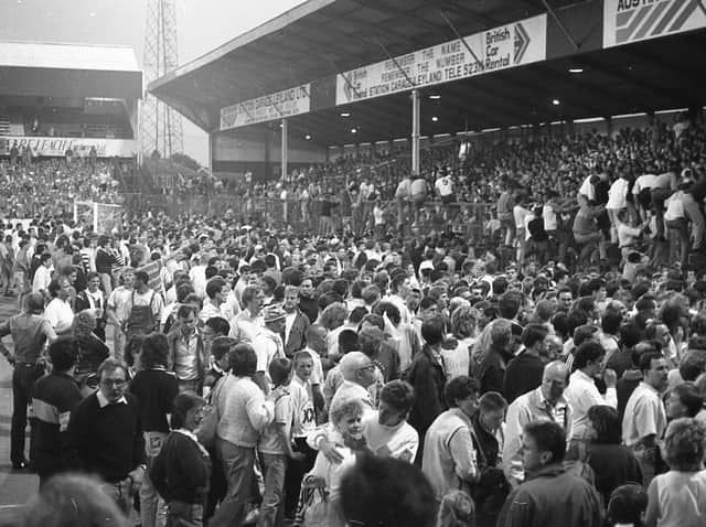 Port Vale fans are forced to evacuate the Town End at Deepdale and come on to the pitch because of a small fire during the play-off game