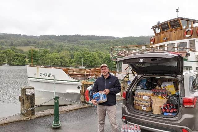James Ventham from Windermere Lake Cruises with some of the food and drink the tourist attraction donated to Morecambe Bay Foodbank.