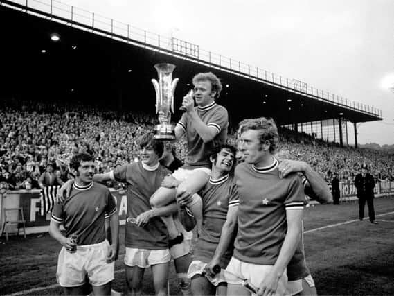 Leeds United captain Billy Bremner holds the Fairs Cup aloft as he celebrates victory with his teammates: (left to right) Johnny Giles, Allan Clarke, Bremner, Mick Bates, Mick Jones