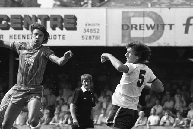 Preston centre-half Tommy Booth challenges in the air against Bournemouth