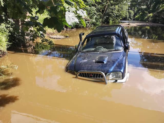The Mitsubishi 4x4 became stuck after trying to drive through the ford at Wyre Lane in Garstang yesterday (June 1)