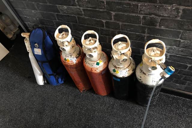 The live-saving oxygen canisters that Jasmine and partner John carry on their backs.