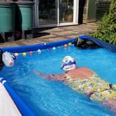 Audrey Hellen swimming in her back garden in Longton