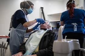 A dentist treats her first patient in PPE at St Michaels Dentist, Wakefield, West Yorkshire, as dentists open after Covid-19 lockdown. June 08 2020.   See SWNS story SWLEopen Today is the first day which dentists have been able to open after the coronavirus lockdown.