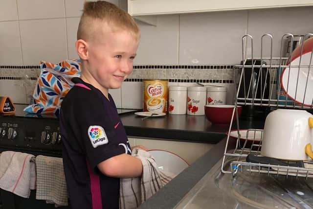 Young Daniel getting stuck in to the washing up