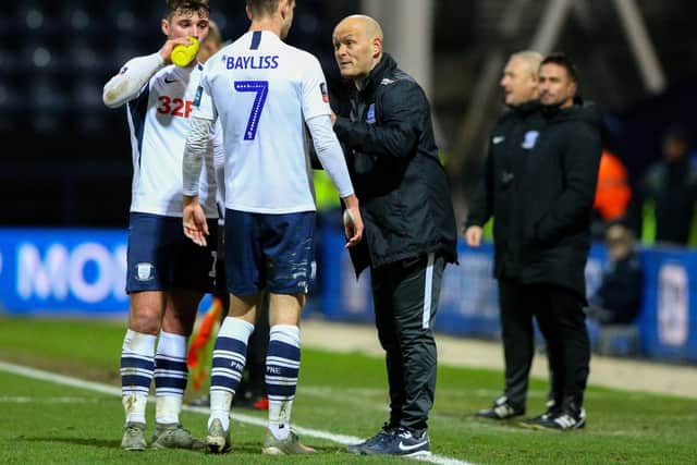 Tom Bayliss and Ryan Ledson get instructions from Preston North End manager Alex Neil