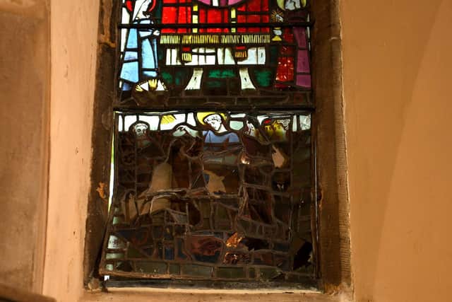 The stained glass window, boarded up for safety and security.
