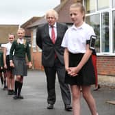 Prime Minister Boris Johnson waits in line in the playground to wash his hands during a visit to Bovingdon Primary School in Bovingdon, Hemel Hempstead, Hertfordshire