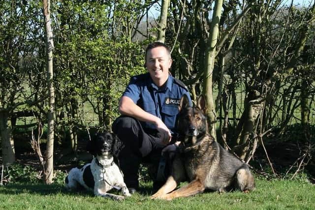 The crime-busting duo - PD Flash (left) and his old pal PD Narvik alongside their handler in 2014