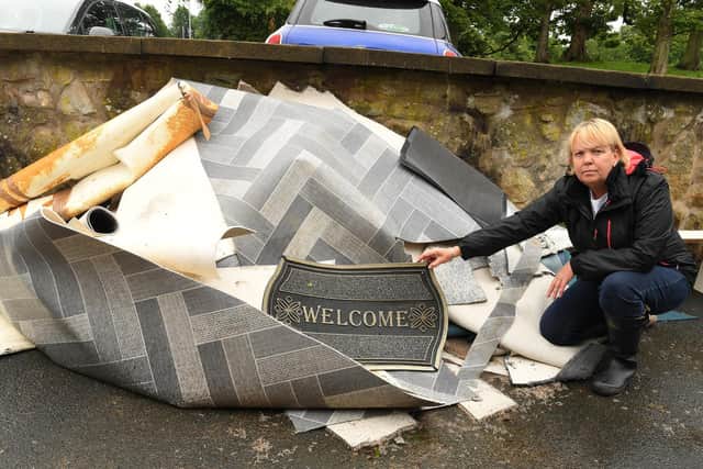 Jackie Cropper with the flooring pulled up from her home.