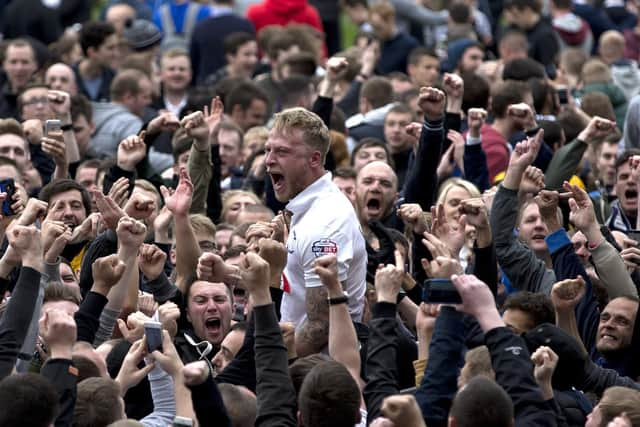 Tom Clarke is chaired off the pitch by celebrating Preston North End fans after the play-off semi-final win over Chesterfield