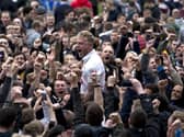 Tom Clarke is chaired off the pitch by celebrating Preston North End fans after the play-off semi-final win over Chesterfield