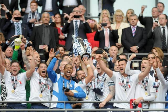 Tom Clarke and John Welsh lift the League One play-off final trophy at Wembley in 2015