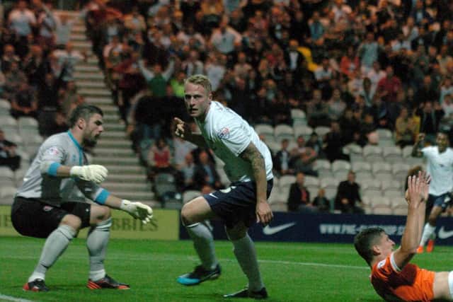 Tom Clarke turns to celebrate after scoring Preston's winner against Blackpool at Deepdale in August 2013