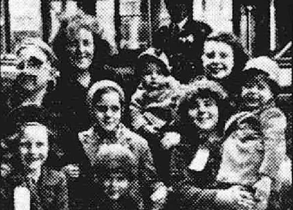 Mrs G Evans, of Harrow, and her family of eight children