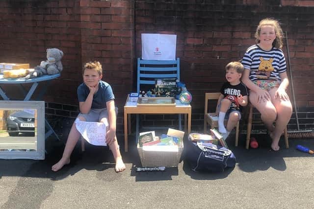 William(left) and Hollie Ball have been hosting a jumble sale on their street to raise money for charity, Save the Children.
