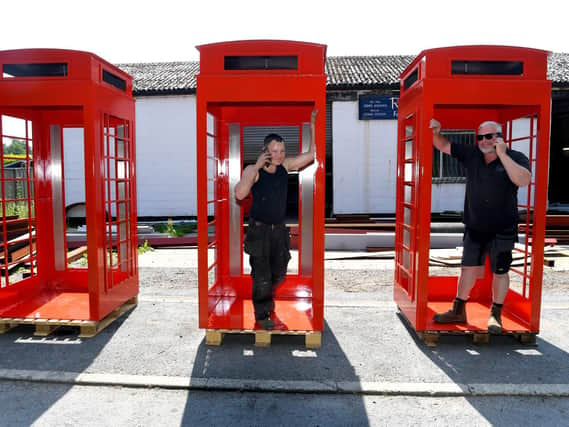 Rob with his son Luke and their phone boxes