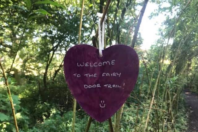 Wooden trinkets and hearts welcome visitors to the trail.