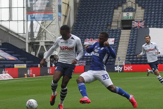 Preston North End right-back Darnell Fisher goes past Cardiff's Junior Hoilett at Deepdale