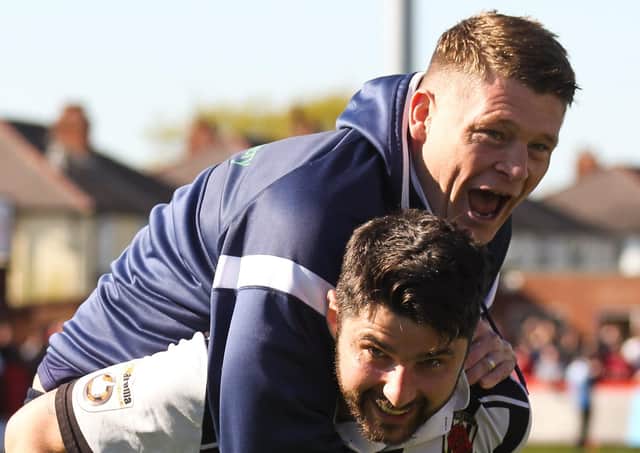 Jonathan Smith jumps on the back of former player Adam Roscoe