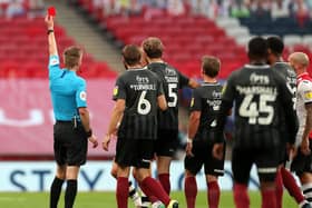 Michael Salisbury brandishes the red card during the League Two play-off final at Wembley