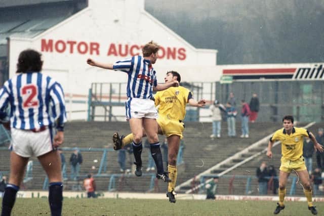 PNE defender Mike Flynn challenges for a high ball at Huddersfield