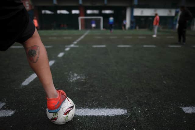 A player steps on the ball during an amateur soccer match at a local club, Play Futbol 5, in Pergamino, Argentina