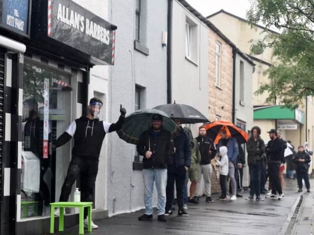 Customers wait patiently in the rain outside Allan's Bamber Bridge shop.