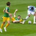 Preston North End left-back Andrew Hughes slides in to tackle Huddersfield's Collin Quaner