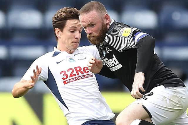 Preston midfielder Josh Harrop tackles Derby’s Wayne Rooney