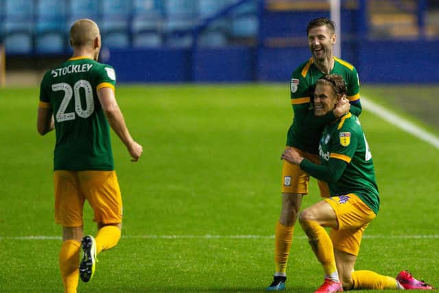 Brad Potts in congratulated by Paul Gallagher and Jayden Stockley after netting PNE's third goal