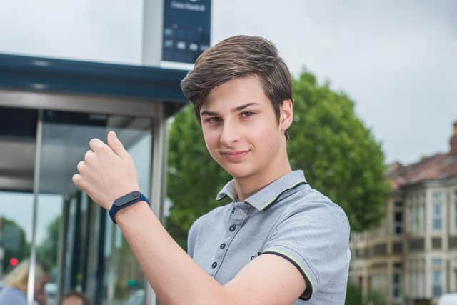 Max Melia with his motion-sensitive wristband device which helps people stop touching their faces and so spreading germs