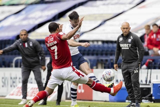 Andrew Hughes and Lewis Grabban challenge, watched by PNE boss Alex Neil