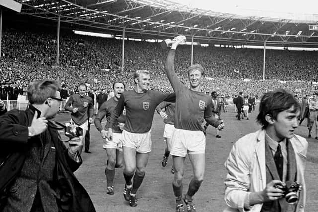 File photo dated 30-07-1966 of England's Jack Charlton (r) holds the Jules Rimet trophy aloft as he parades it around Wembley with teammates Ray Wilson (l), George Cohen (second l) and Bobby Moore (second r) following their 4-2 win.