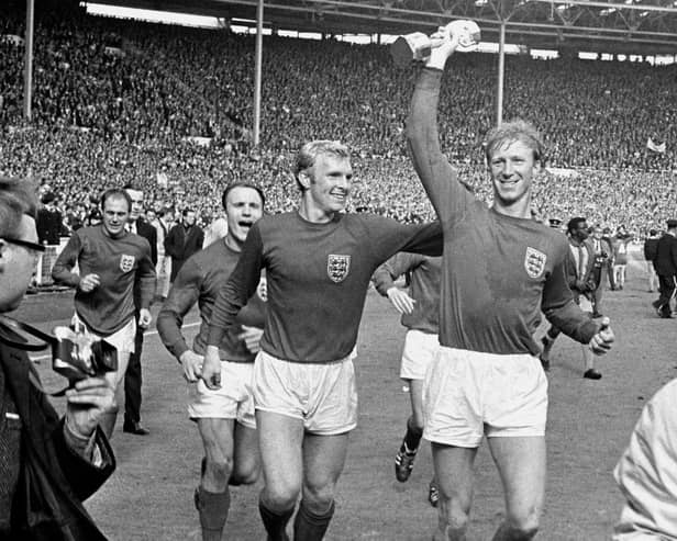 Jack Charlton holds aloft the World Cup with Bobby Moore
