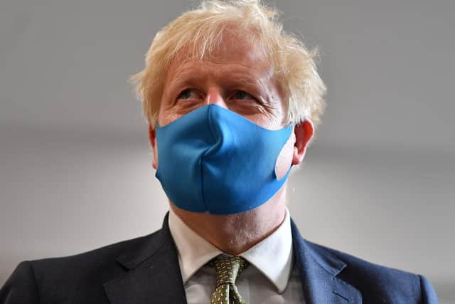Boris Johnson, wearing a face mask or covering (Photo by Ben Stansall-WPA Pool/Getty Images)
