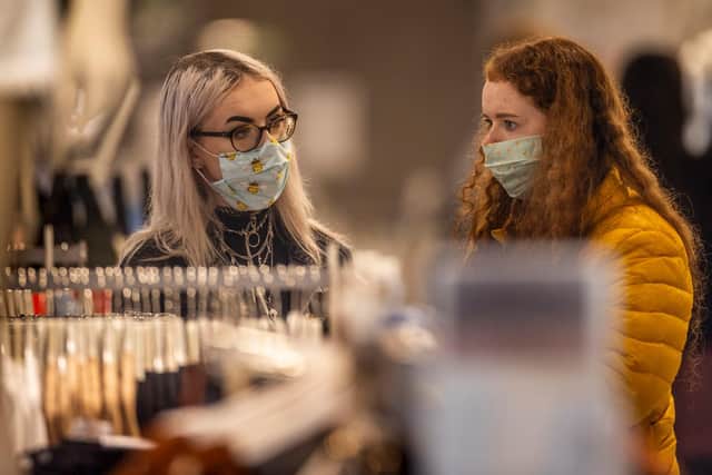 Caitlin Lynch (left) and Anna Kirkwood wearing face masks as they browse