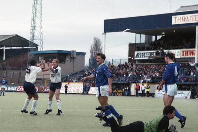 Preston defender Mike Flynn celebrates with team-mate David Thompson after scoring against Birmingham at Deepdale in April 1992