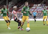 Preston North End's Tom Barkhuizen (centre) and Daniel Johnson (left)  in action against Brentford