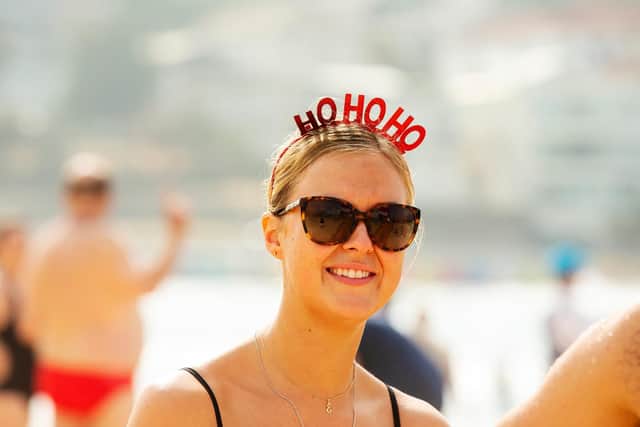 A woman wearing a Christmas themed headpiece looks on at Bondi Beach on December 25, 2019 in Sydney, Australia